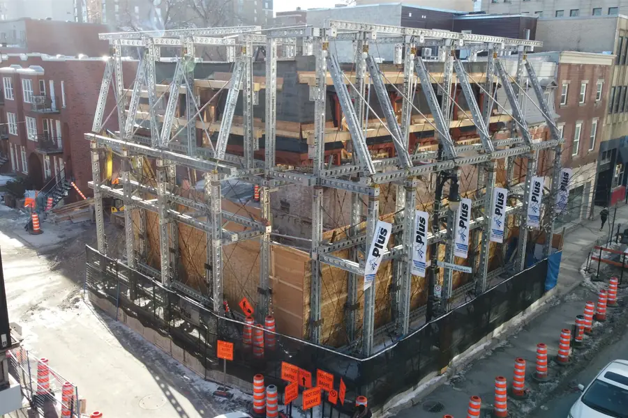 Temporary structure inserted between two occupied buildings