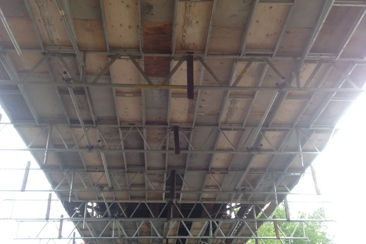 Work deck suspended beneath a bridge deck